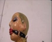 Cute girl encased in latex, with a ballgag, locked on a sybian and to cum from ballon cum
