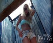 Hidden camera in a beach cabin.Tanned blonde in denim shorts . from tanned blonde in a beach cabin